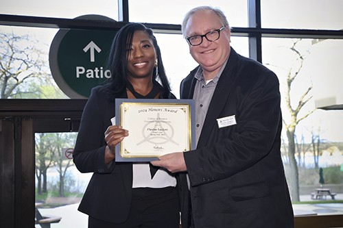 Two people holding a certificate